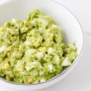 white bowl with avocado egg salad.