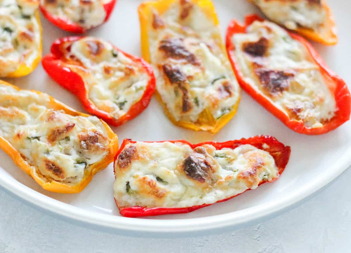 plate with air fryer mini peppers stuffed with cream cheese.