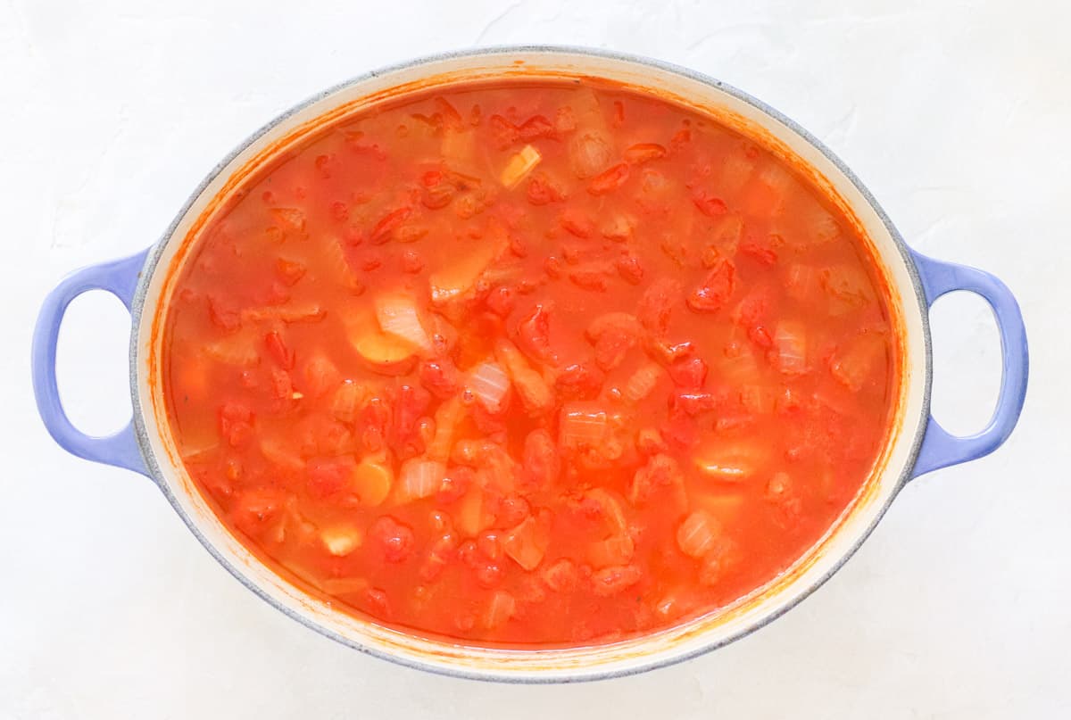 tomato soup in a blue pot after cooking but before blending together.