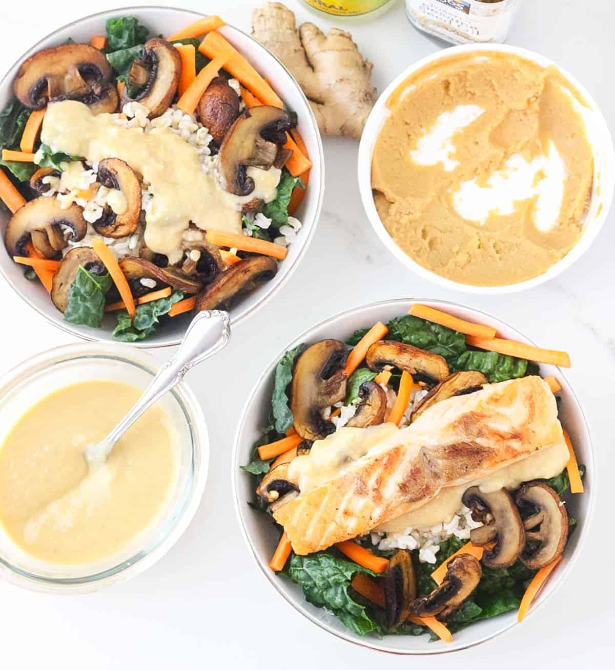 bowl of miso sauce, container of white miso paste, next to two Miso Brown Rice and Kale Bowls topped with salmon.