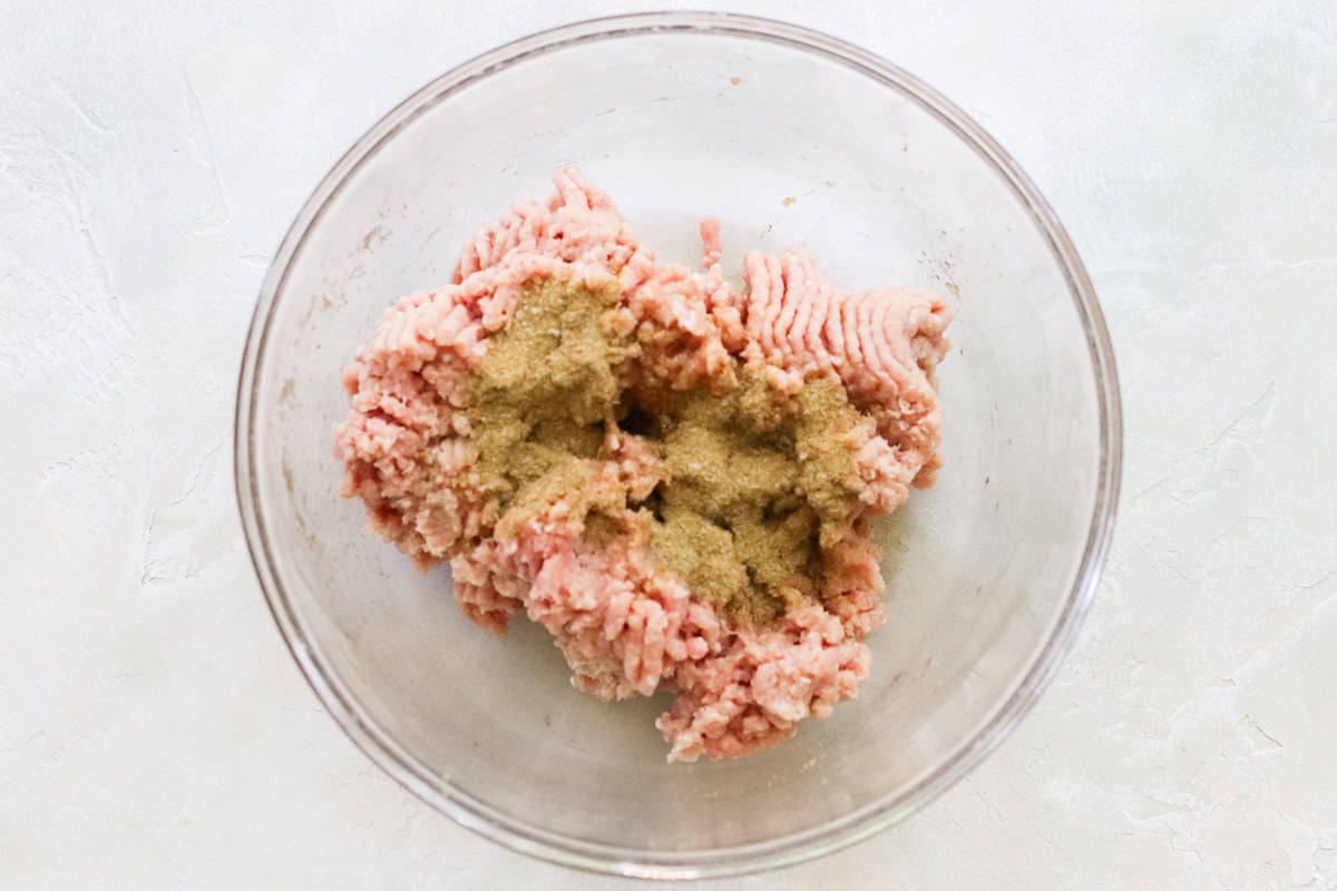 bowl with ground turkey and spices before mixing.