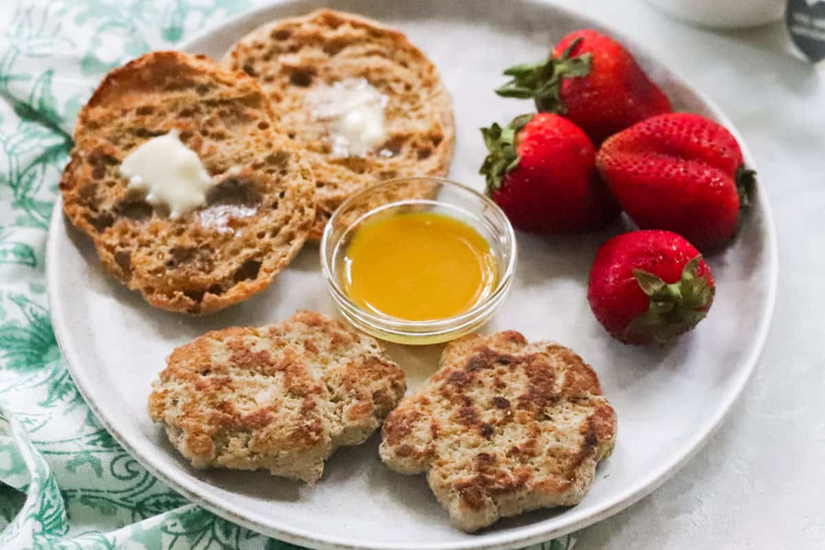 plate with homemade breakfast sausage patties, maple mustard sauce, english muffins, and strawberries.