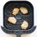 air fryer basket with cooked homemade breakfast sausage patties.