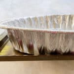 disposable roasting pan on a baking sheet.