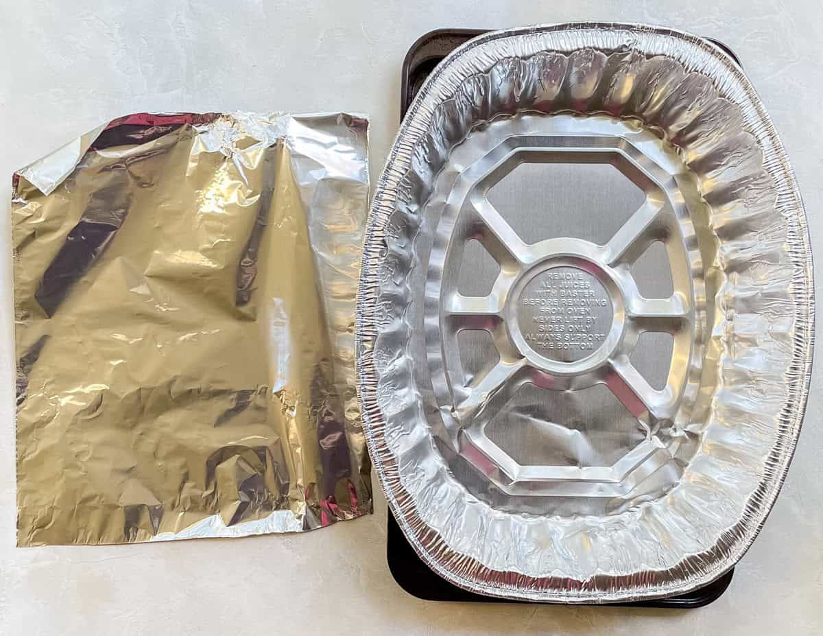 sheet of foil next to a disposable oven roasting pan.