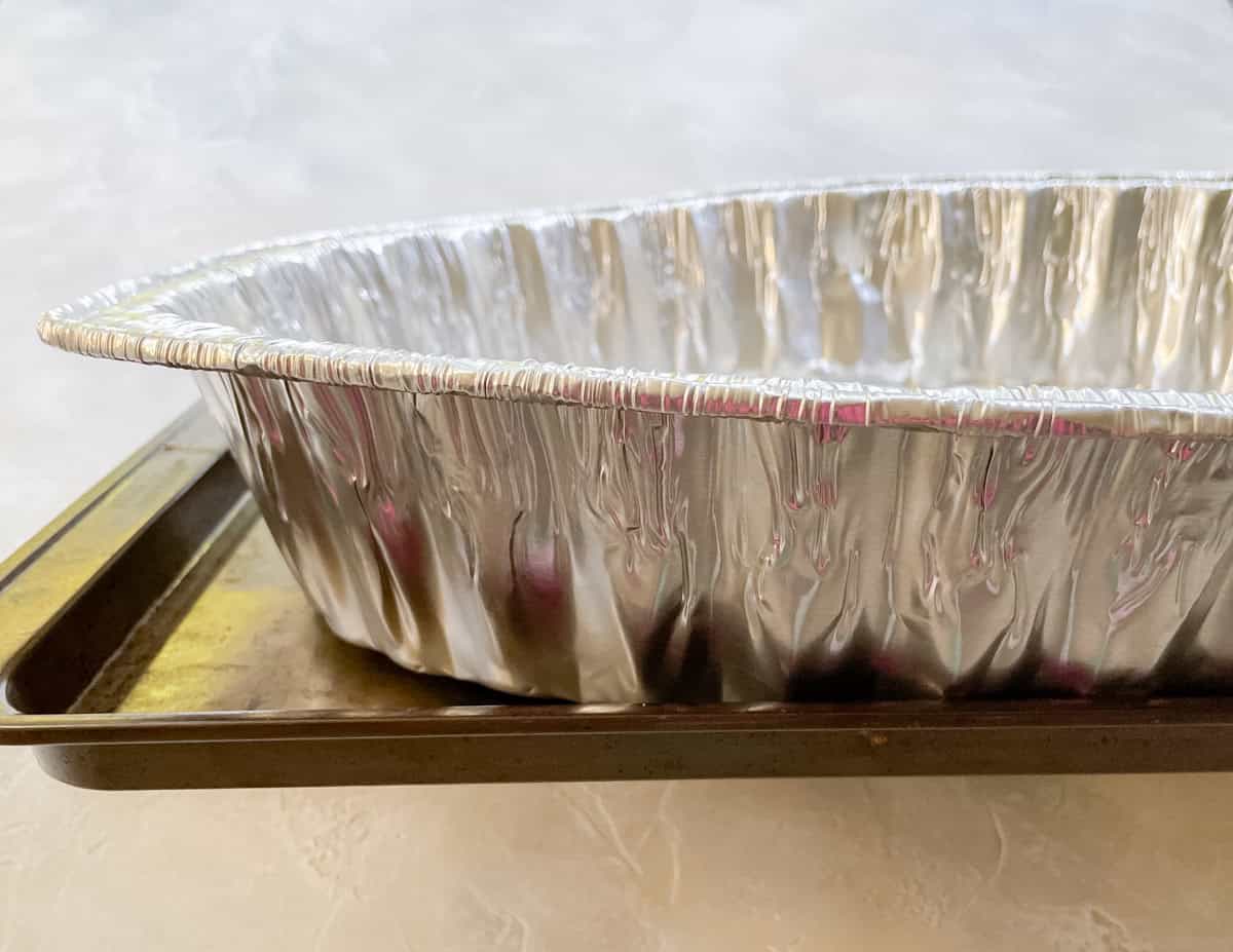 disposable roasting pan on a baking sheet.