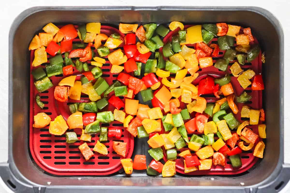 air fryer basket filled with roasted bell peppers.