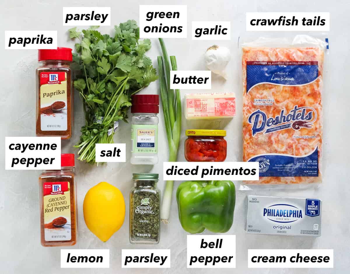paprika, cayenne pepper, parsley, lemon, salt, green onion, garlic, stick of butter, jar of diced pimentos, green bell pepper, block of cream cheese, bag of crawfish tails.
