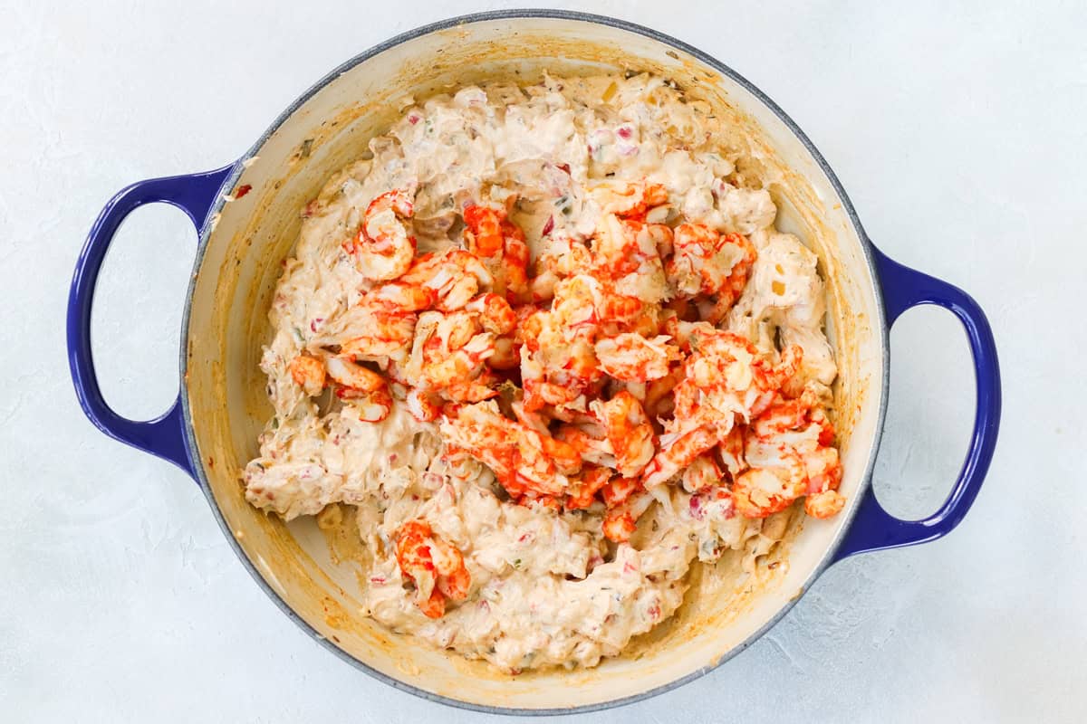 blue pan with cream cheese, spices, sauteed veggies, diced pimientos, and crawfish tail meat.