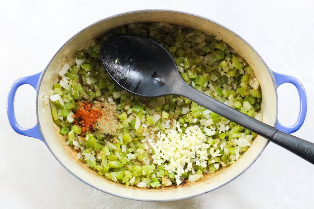 pot with sauteed celery, onions, and green bell peppers with cayenne pepper, dried thyme, and fresh garlic.