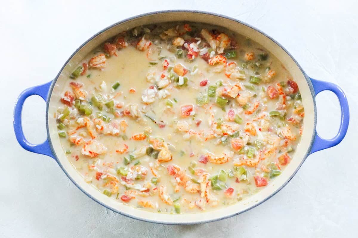 crawfish mixed with veggies, rice, milk, and water before baking into a casserole.