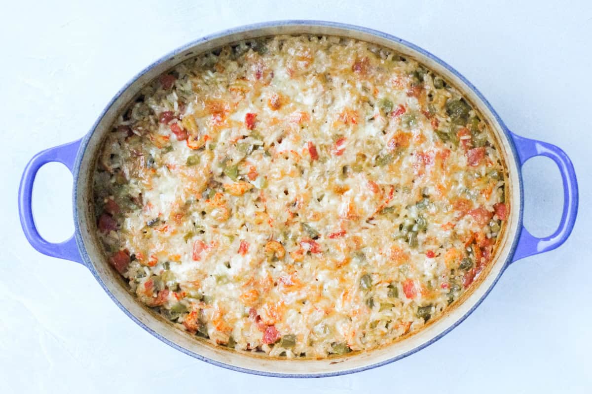 baked crawfish casserole recipe fresh from the oven in a blue dutch oven.