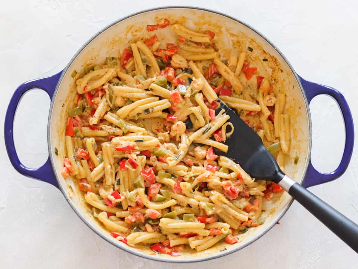 blue pan with pasta tossed in leftover crawfish dip.