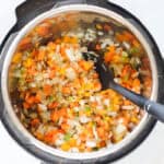 onions, bell peppers, and carrots sauteed in an instant pot.