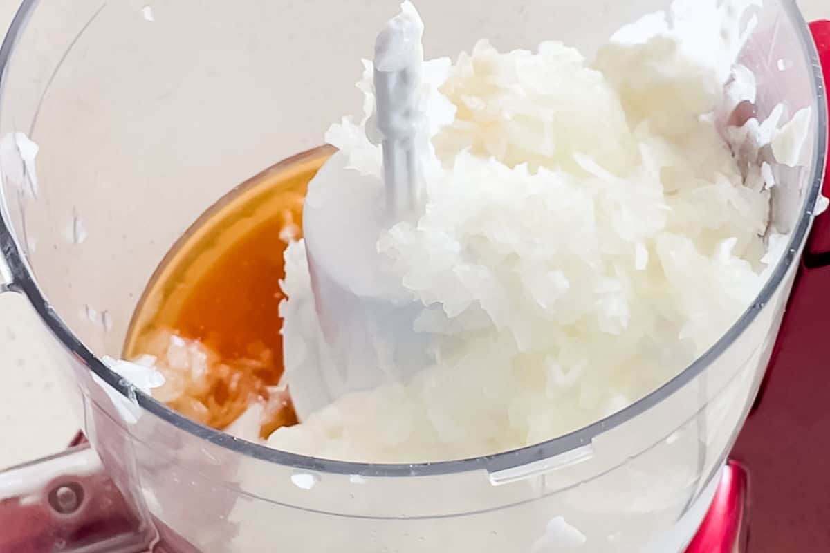 red food processor with cottage cheese, diced onion, and pimento liquid.