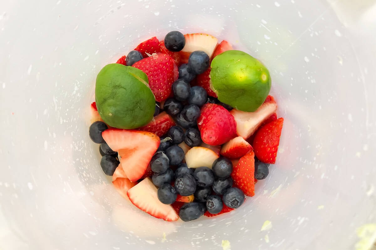 pitcher with fresh sliced strawberries, blueberries, and lime.