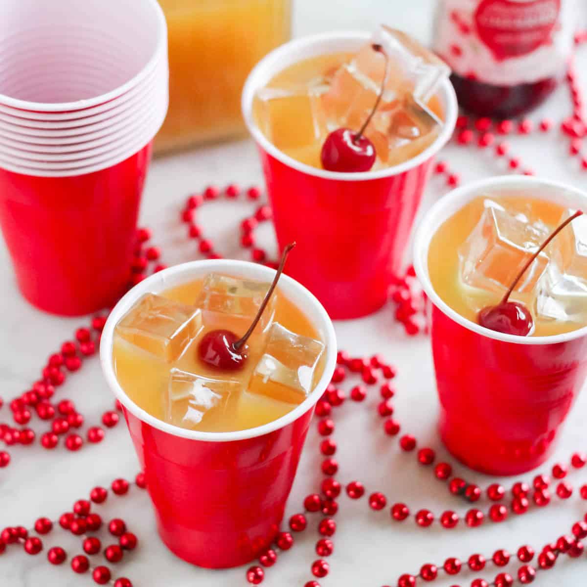 yellowhammer drinks in red cups with cherries on top.