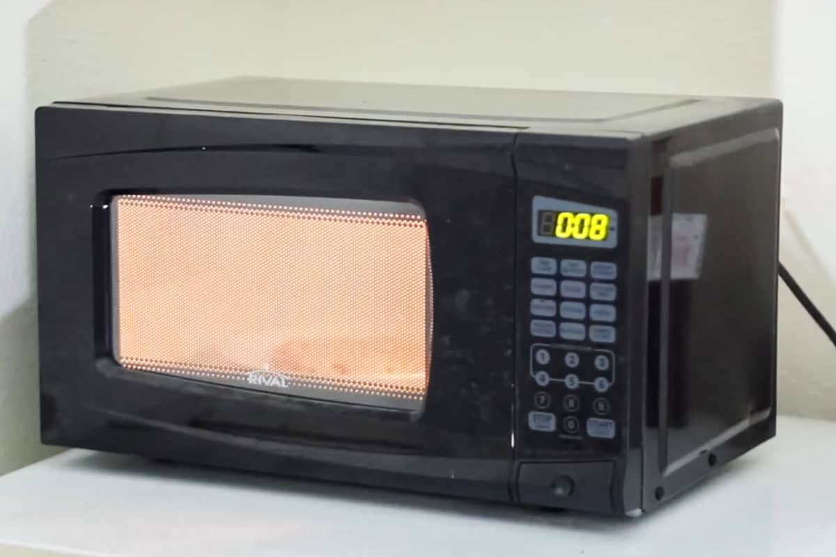 cookie microwaving in a microwave with 8 seconds remaining on the timer.